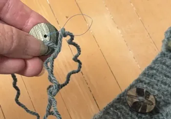 Floss Threader Down on Micheles Sweater